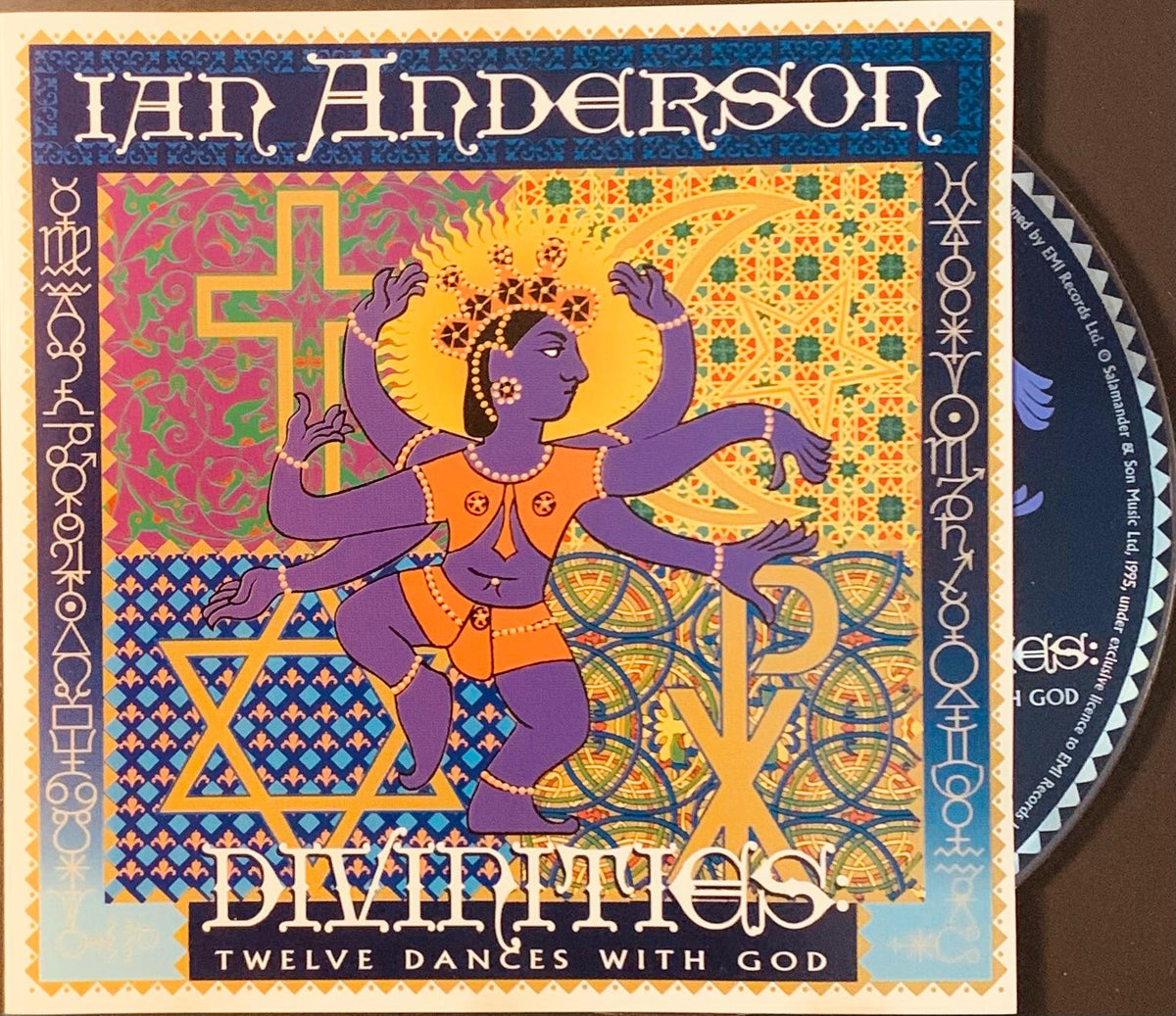 Ian anderson cd divinities twelve dances with god features a vibrant purple deity with orange garment on geometric background