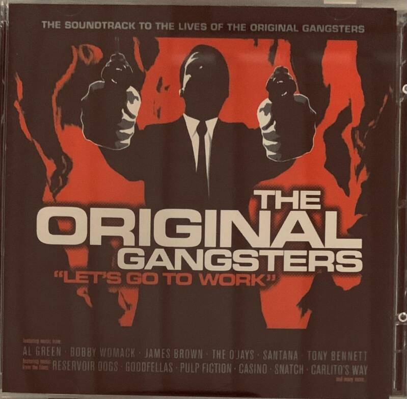 The original gangsters cd cover features a bold black and red graphic of a suited man holding guns against a fiery background