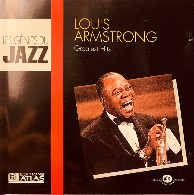 Black vinyl record album cover featuring louis armstrong holding trumpet with gold louis armstrong greatest hits text