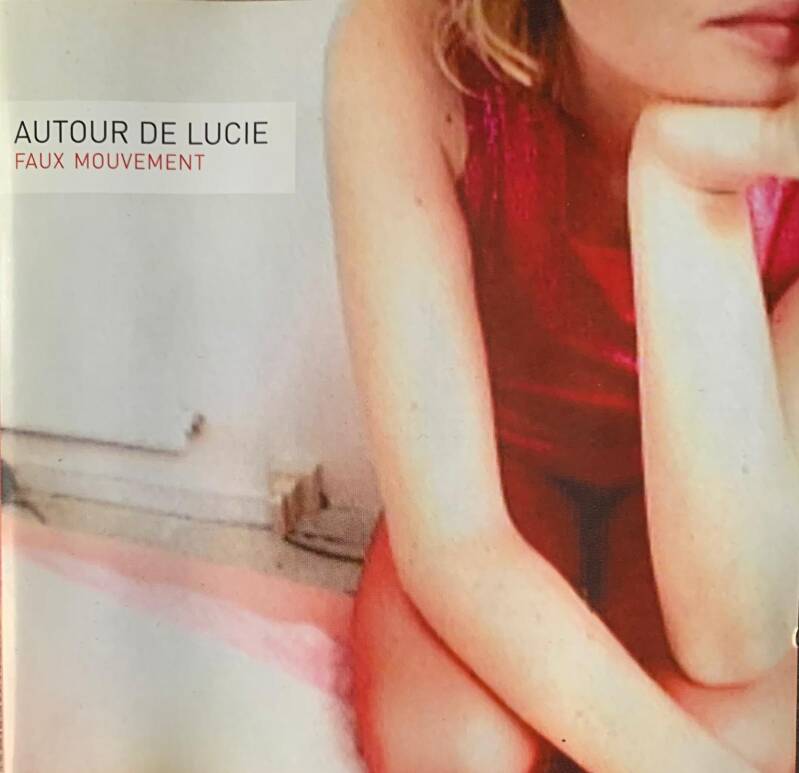 A woman wearing a shiny red dress on the front cover of Autour De Lucie Faux Mouvement CD
